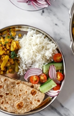 zoomed overhead image of Lauki Chana Dal on steel dish with rice| cookingwithparita.com