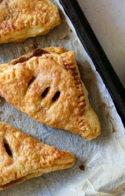 overhead photo of vegan apple turnovers with two green apples