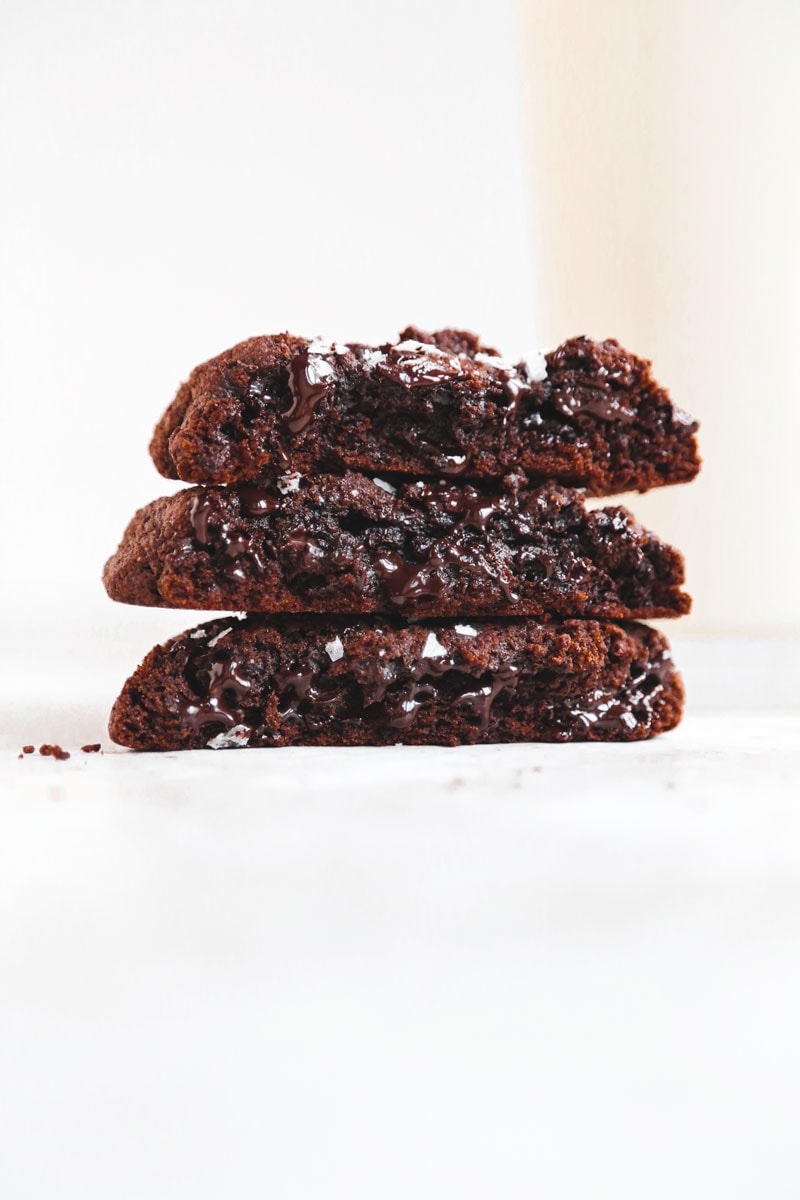 image of vegan NYC double chocolate chip cookies with a glass of oat milk | cookingwithparita.com