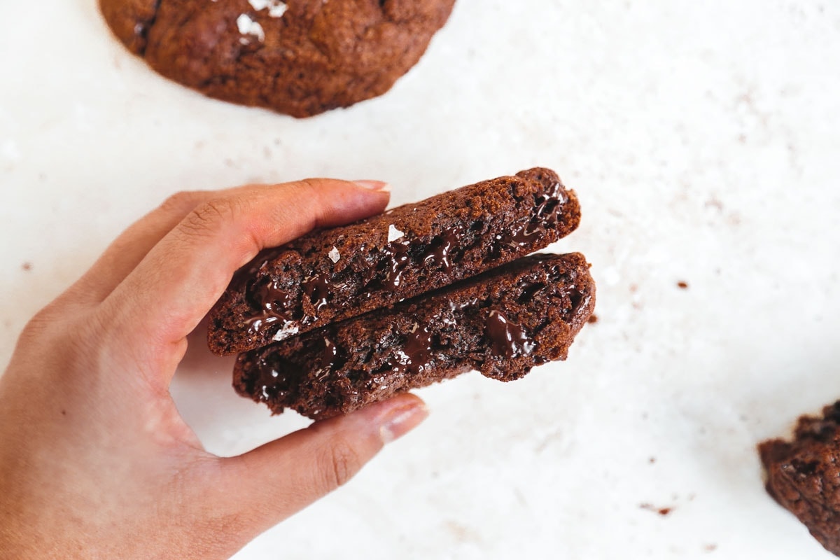 vegan NYC double chocolate chip cookie being held | cookingwithparita.com
