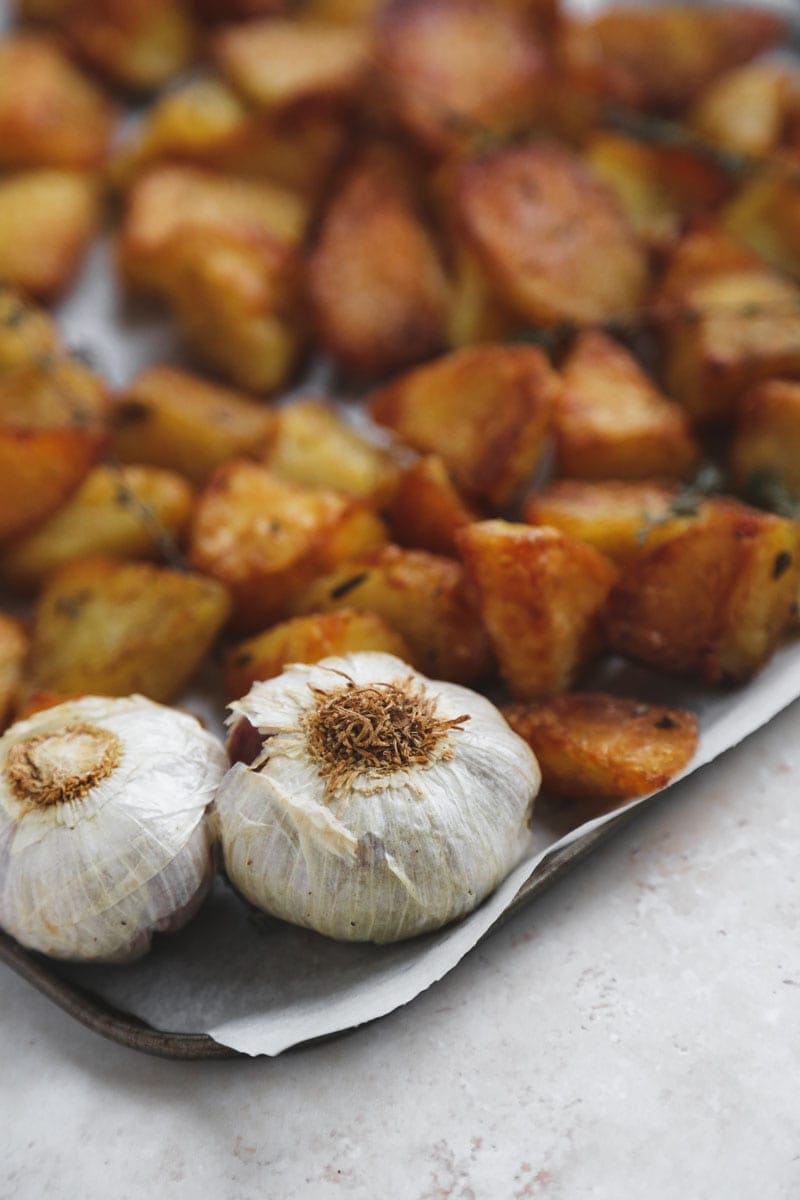 Close up of Crispy Roast Potatoes and Garlic | cookingwithparita.com