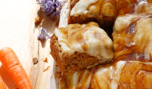 image of vegan carrot sheet cake with caramel and cream cheese frosting dripping around the cake