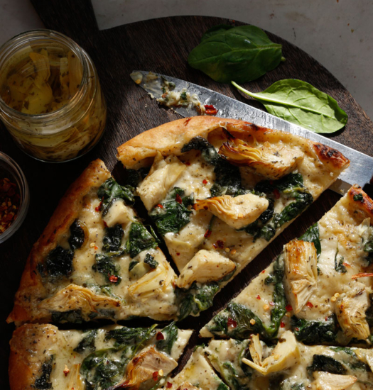 Images of sliced vegan Image of vegan Spinach Artichoke Pizza
