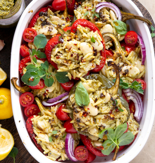 Image of Vegan Lemon Garlic Orzo Stuffed Peppers with Basil Pesto with fresh herbs on top