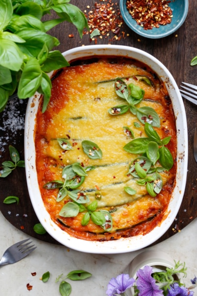 Image if vegan zucchini lasagna topped with fresh basil and chili flakes